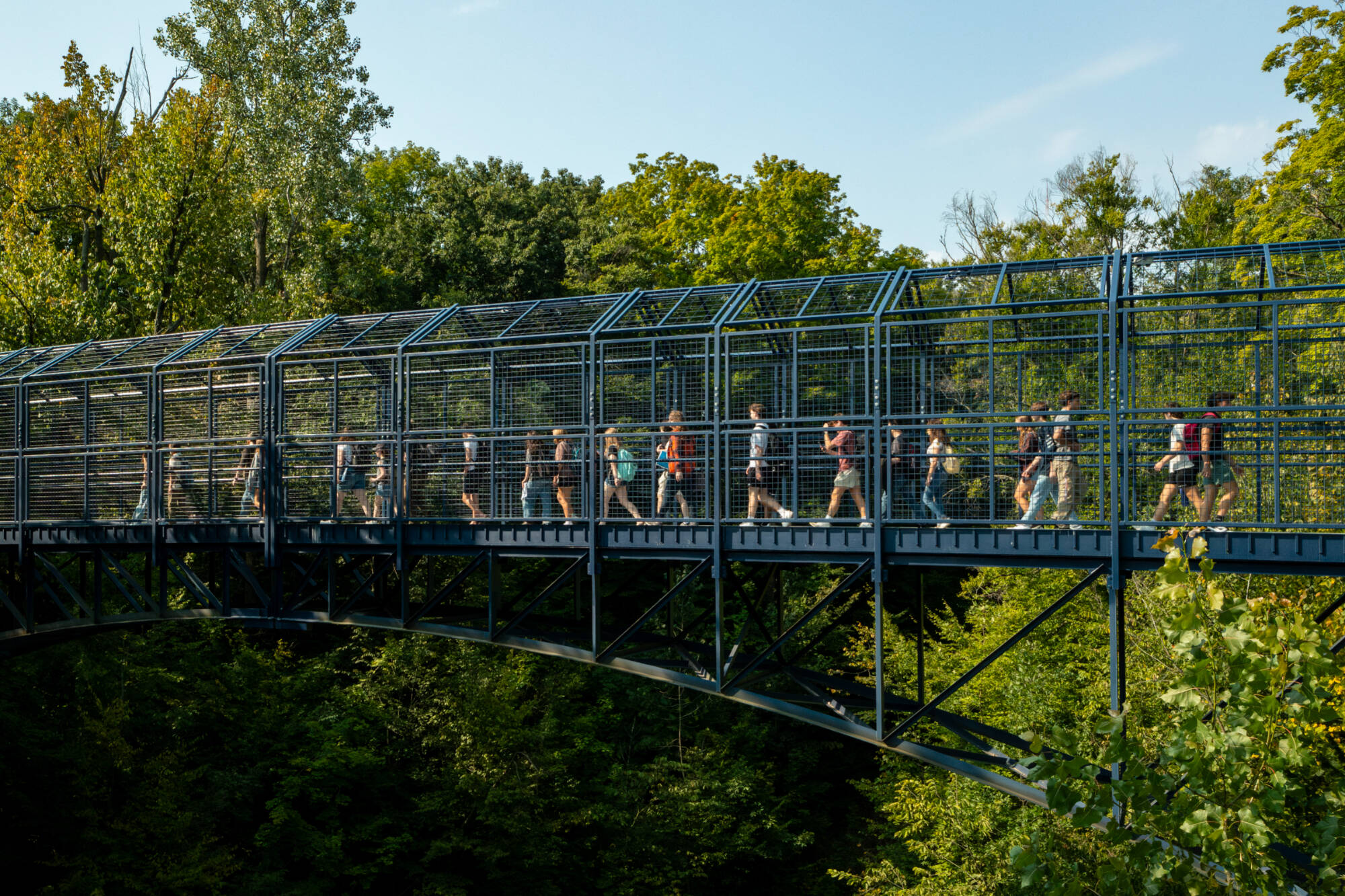 students walk across bridge on the valley campus